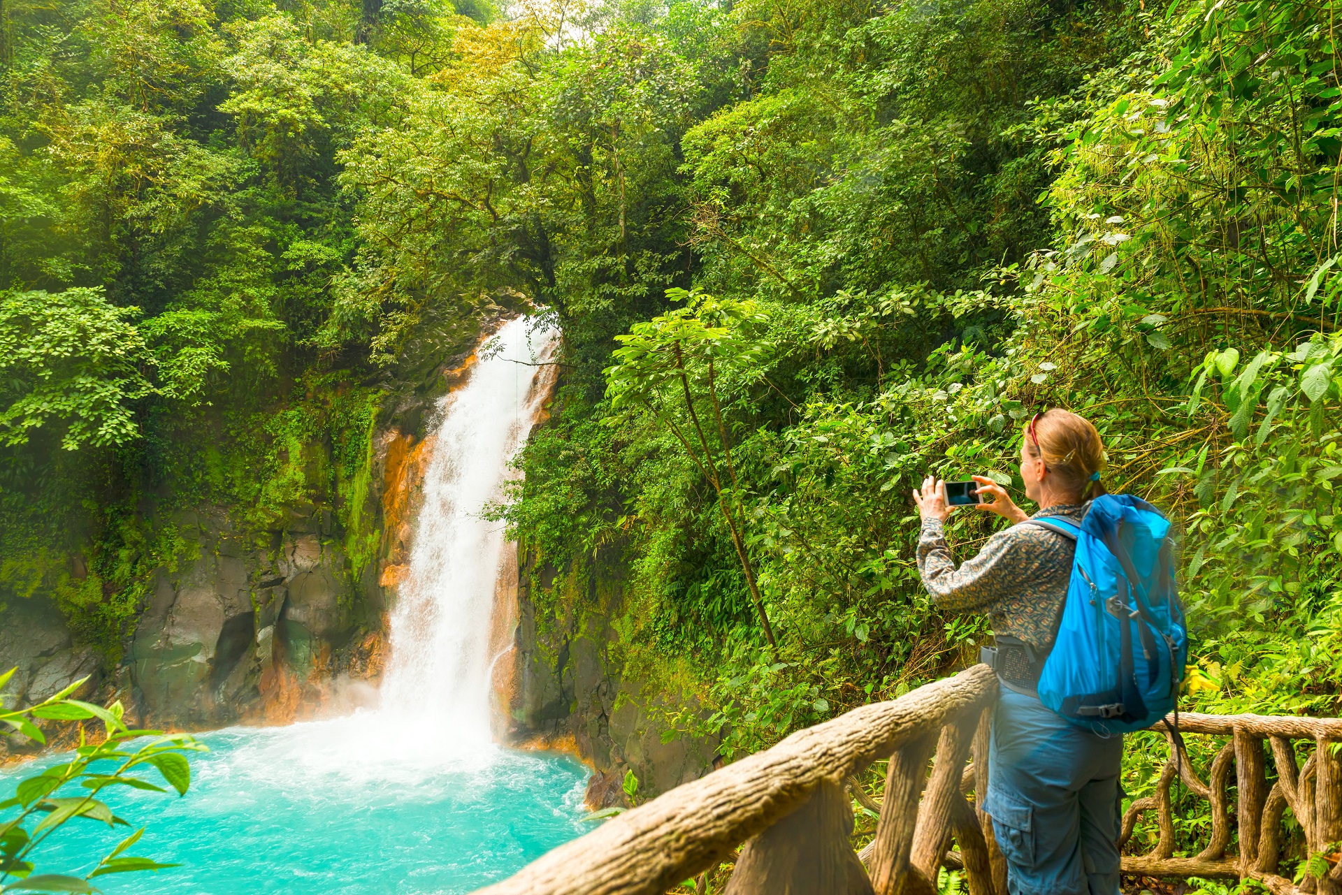 Woman on a solo travel tour near a waterfall.