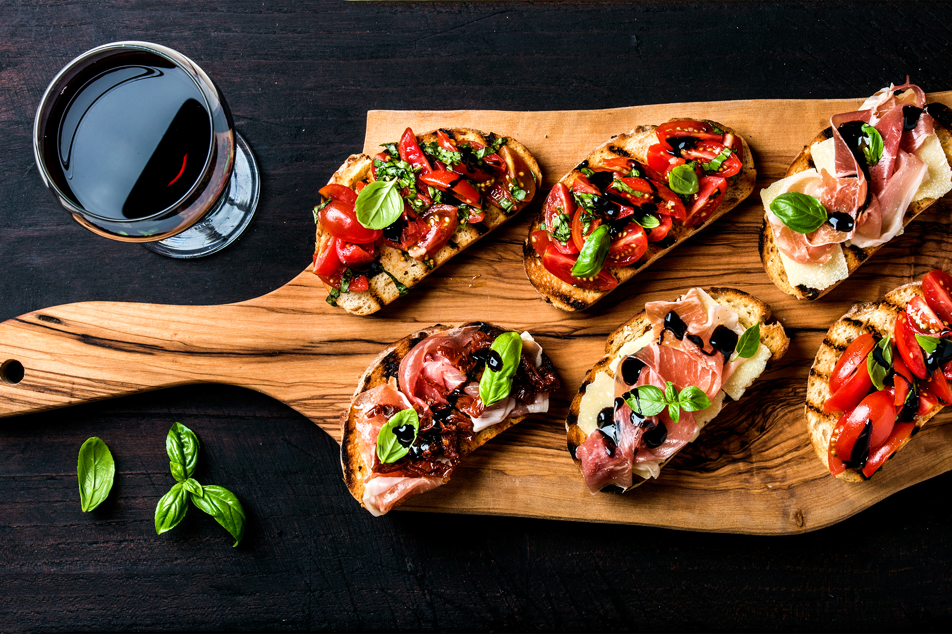 Brushetta set and glass of red wine. Small sandwiches with