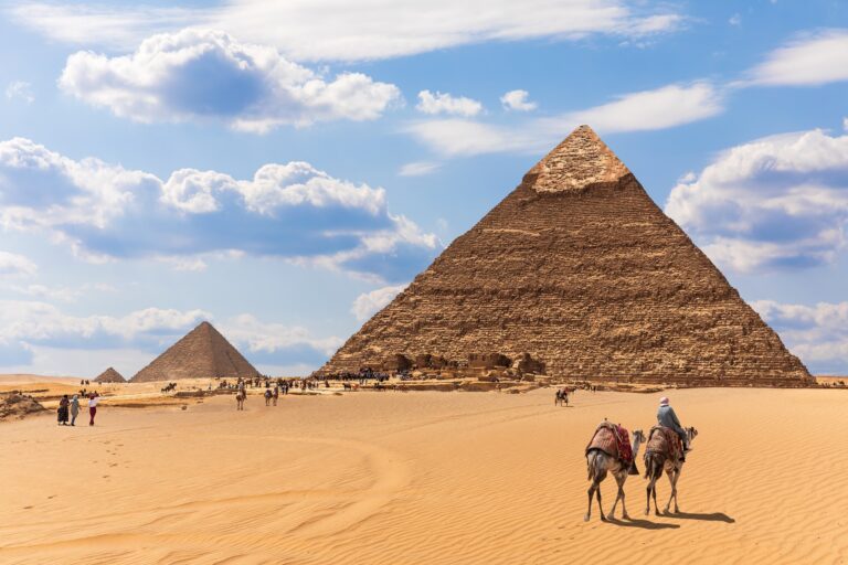 The Pyramids and bedouins in the desert of Giza, Egypt