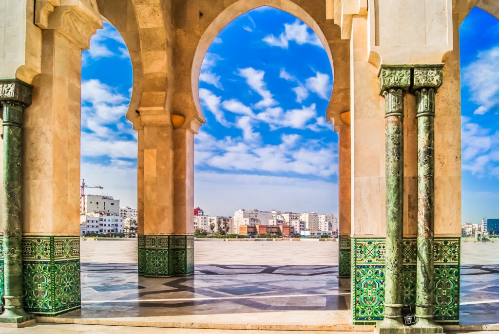 A large stone building with arches and columns reminiscent of those you might discover on Morocco Escorted Tours.