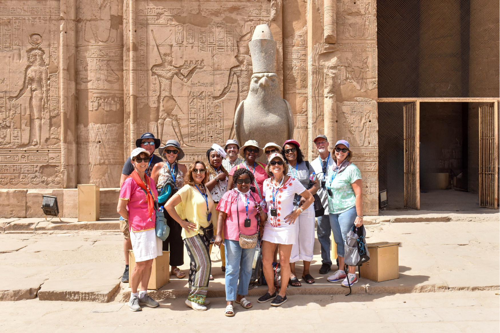 A smarTours group poses in front of a statue of Horus in Spring 2023