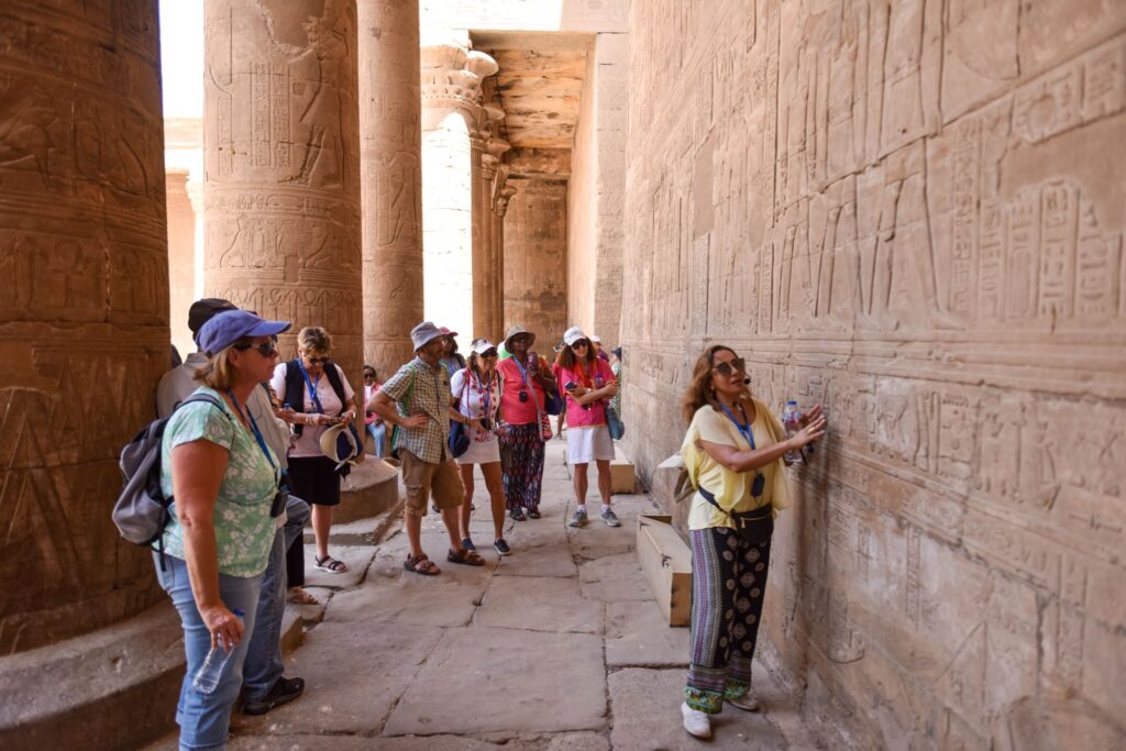 Our Tour Director translates hieroglyphics for the group in Spring 2023