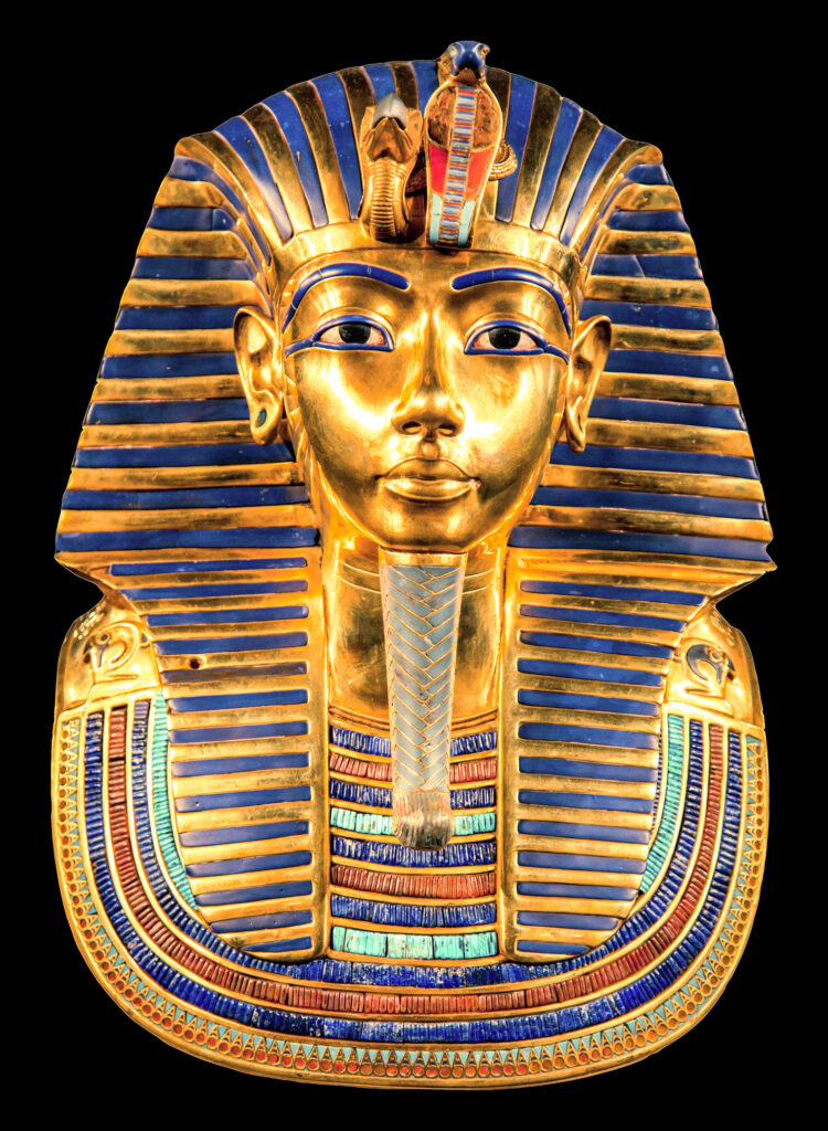 The golden funerary mask of Pharaoh Tutankhamun, with its blue and gold striped headdress and ornate collar, stands as a timeless emblem of ancient Egyptian royal attire against a black background. This iconic artifact captures the essence of travel photos that transport you to another era. It will be on display at the grand egyptian museum.